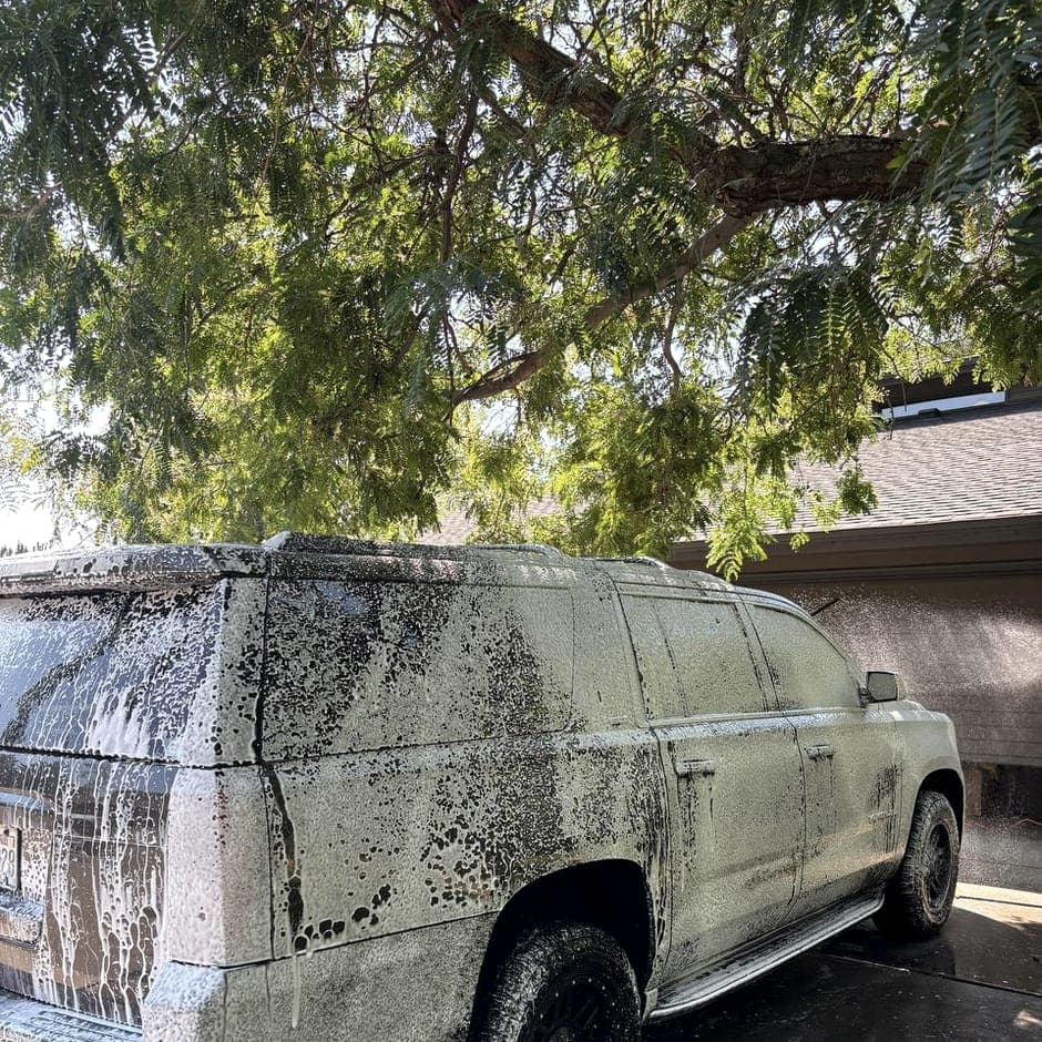 Vacuum nozzle drawing soil out of a car carpet