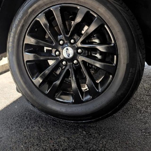 Wheel and tire of a Ford Expedition cleaned by hand